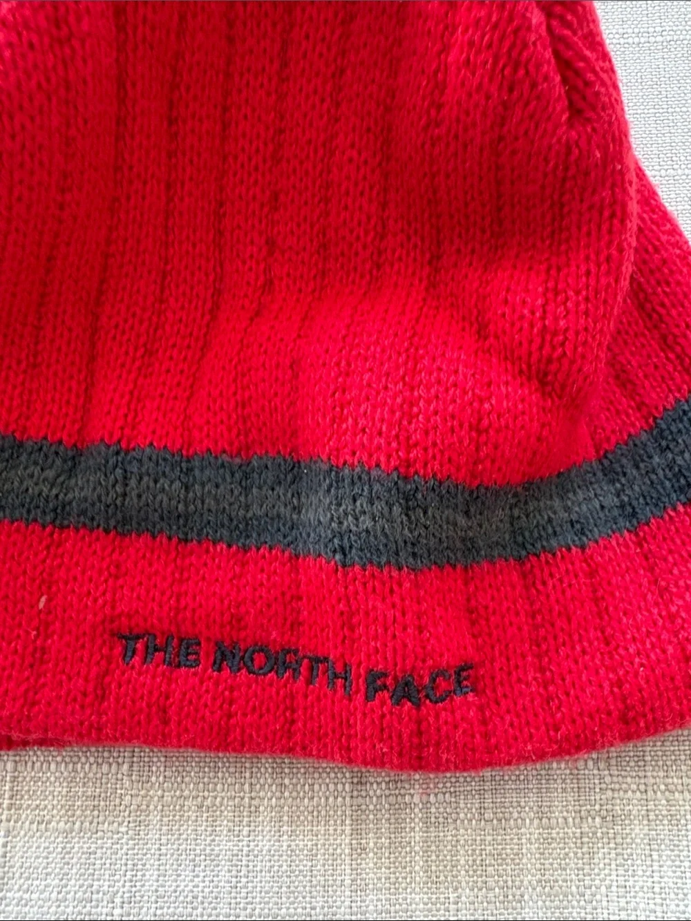 The North Face Red Beanie with Dark Gray Stripe